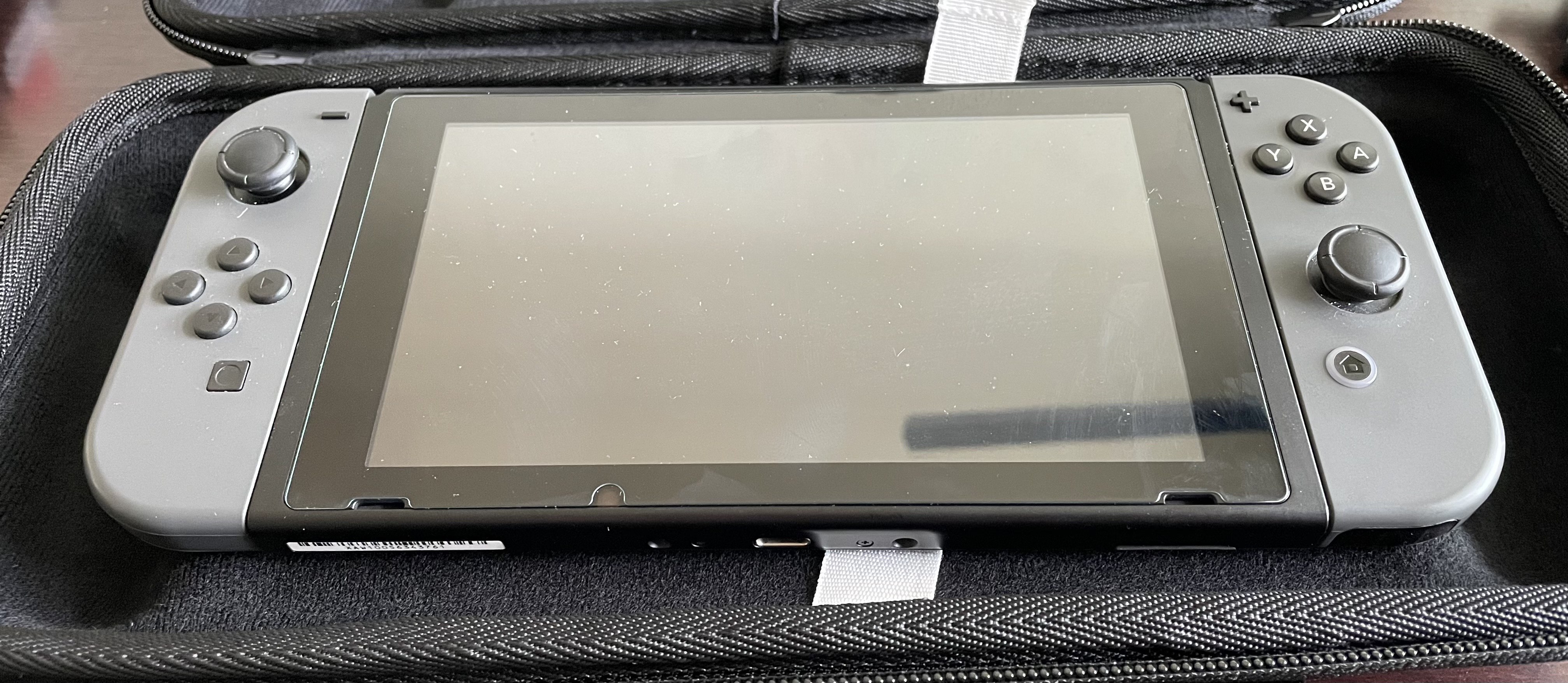 A Nintendo Switch sits inside the Deck's case with space to spare