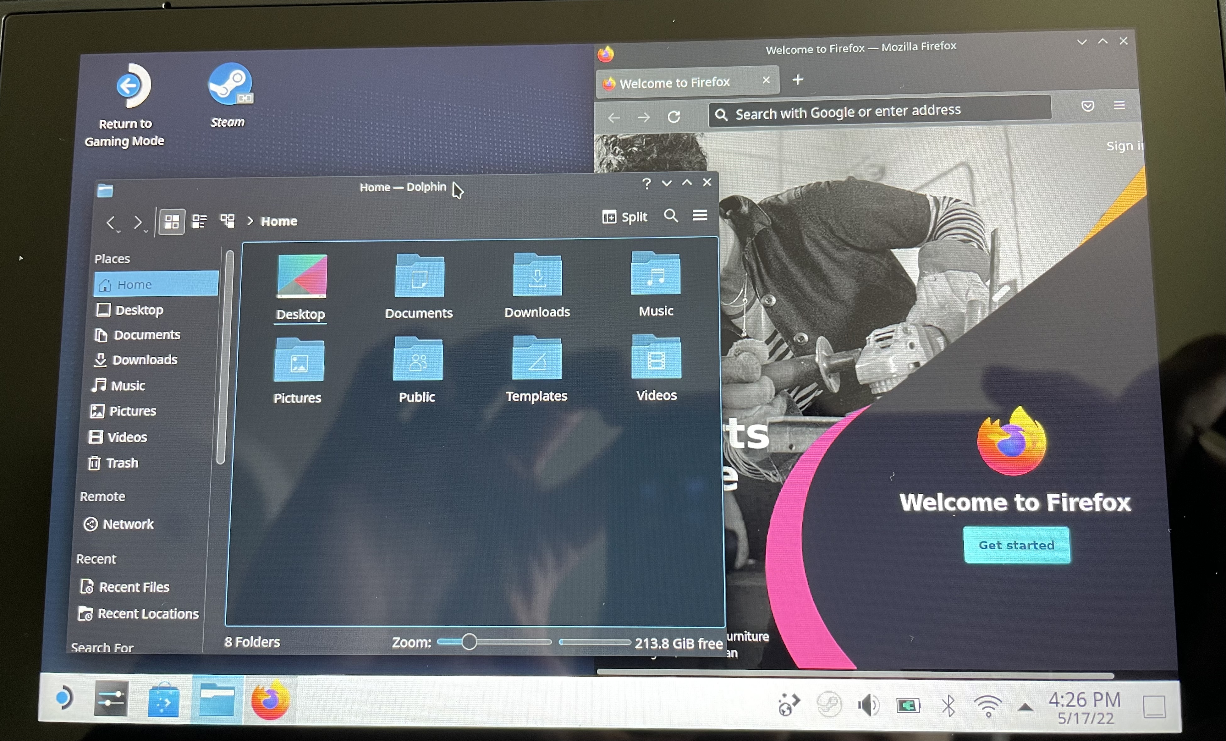 A picture of the Deck running in Desktop Mode. A KDE Plasma session is shown, with Firefox and Dolphin (a file manager) opened in two separate windows.