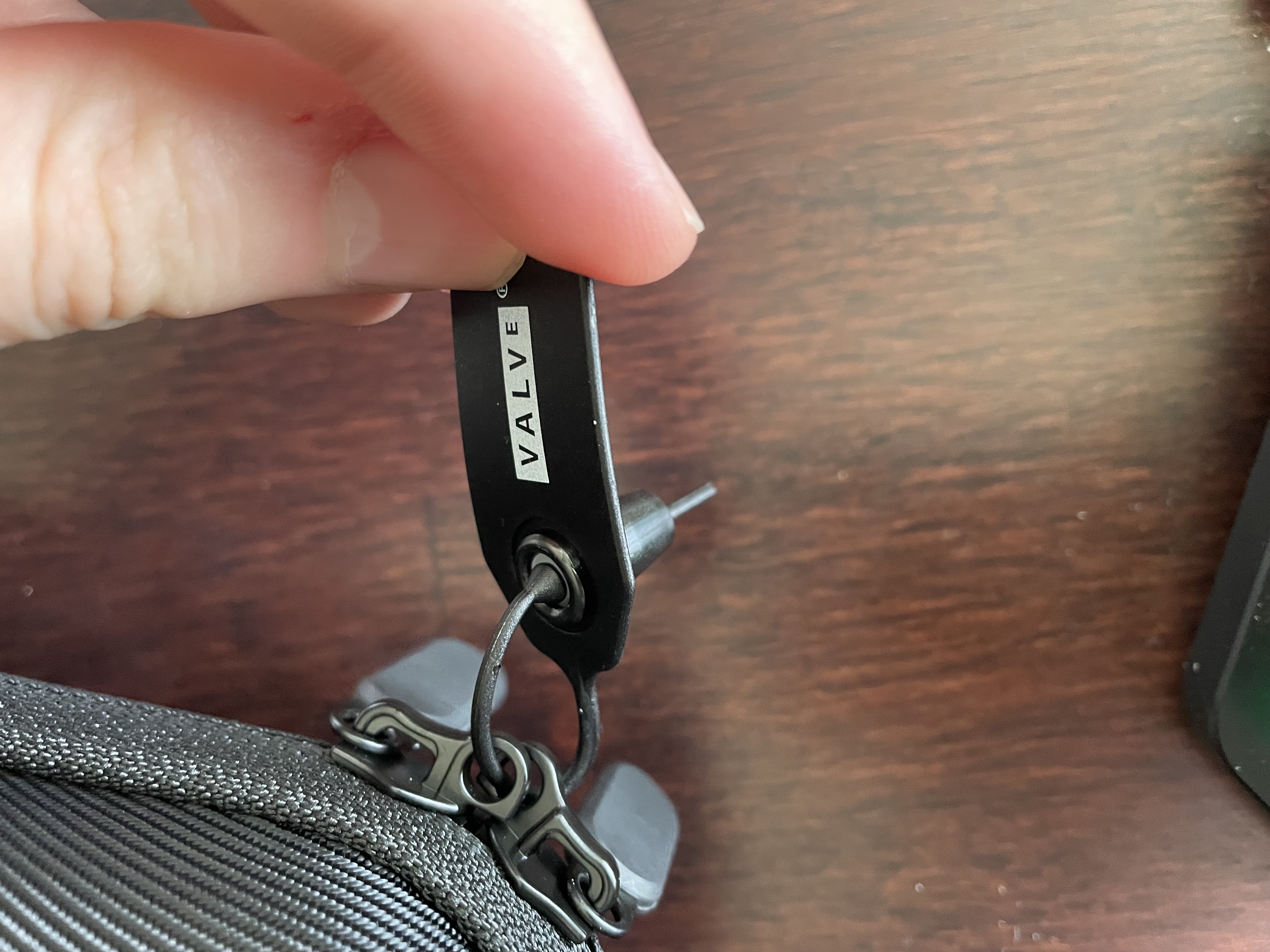 A Valve-branded tag which loops through and locks the case's zippers.